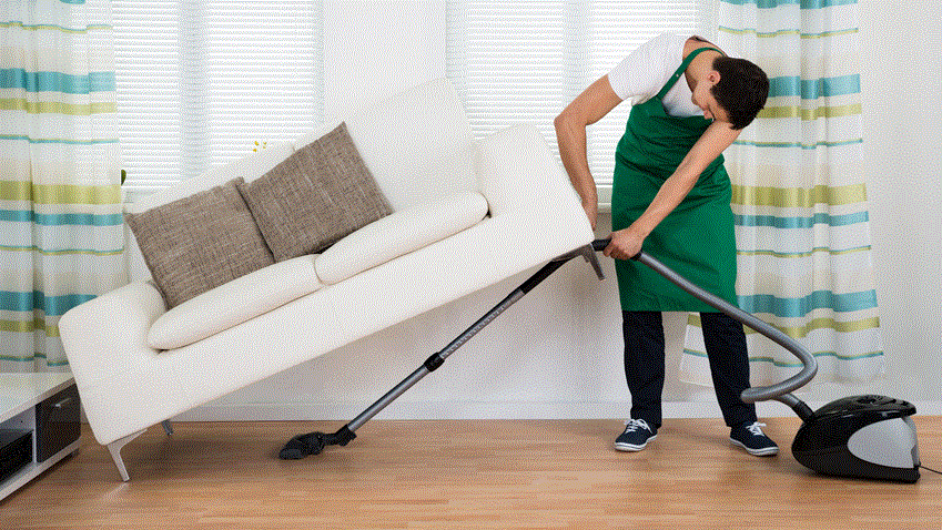 cleaner cleaning under a couch