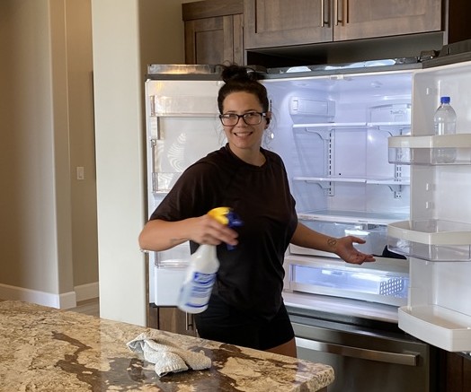 Krisandra cleaning a fridge